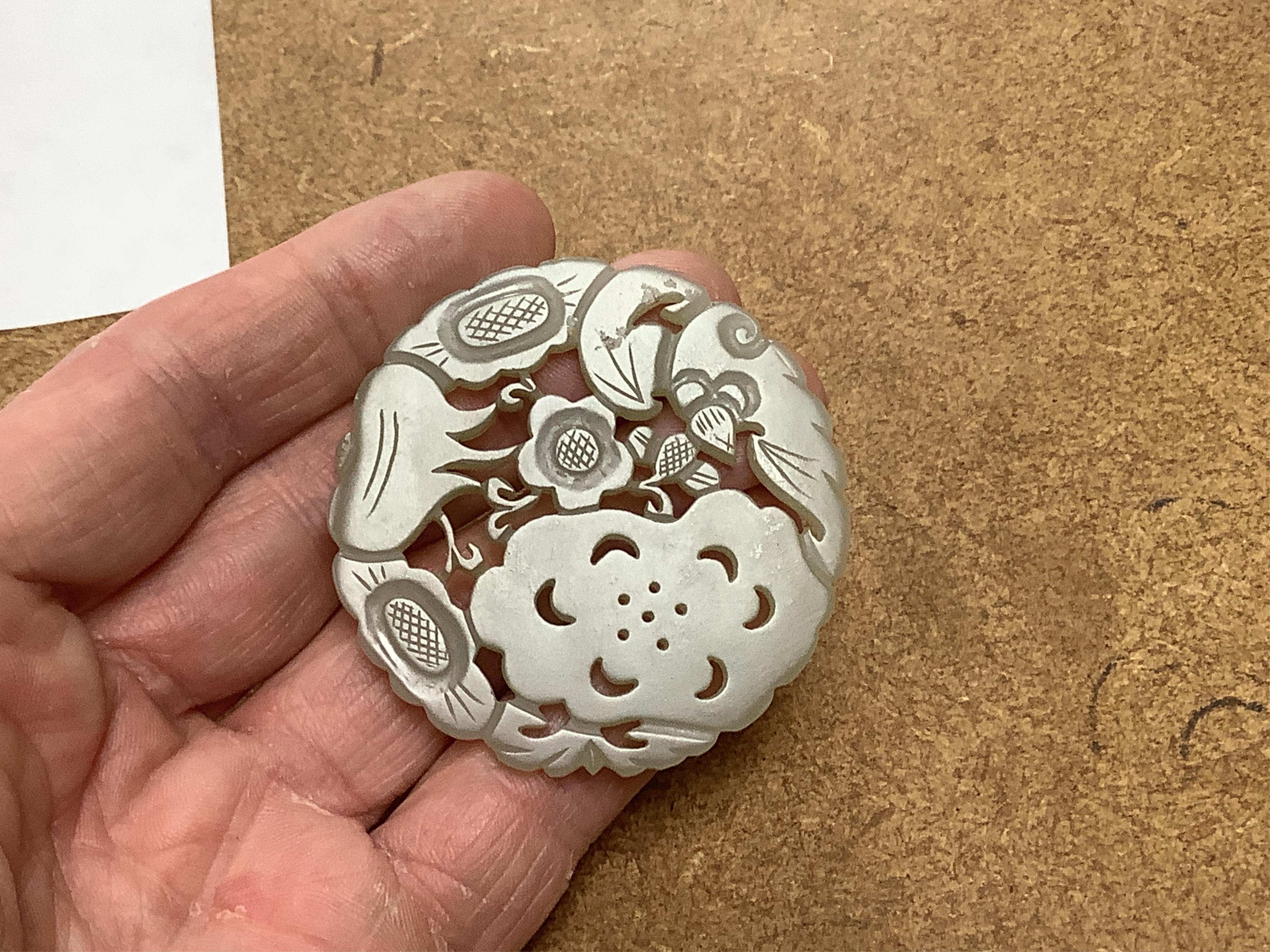 Two Chinese celadon jade circular plaques, 19th century, 5.5cm diameter